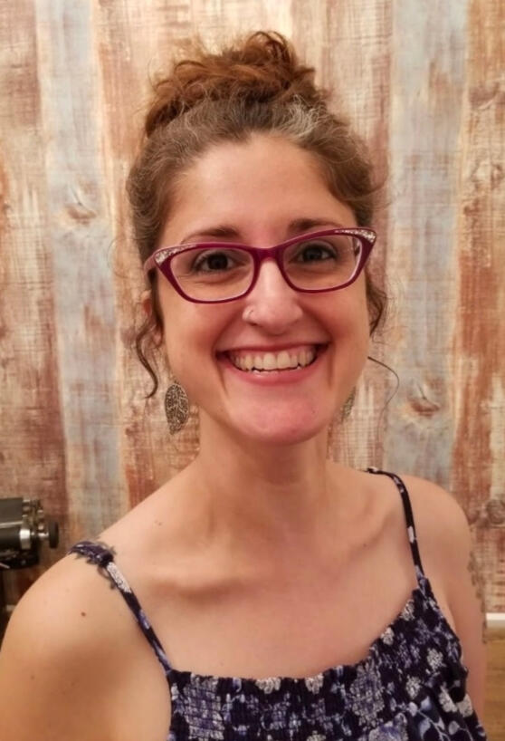 woman smiling wearing red glasses